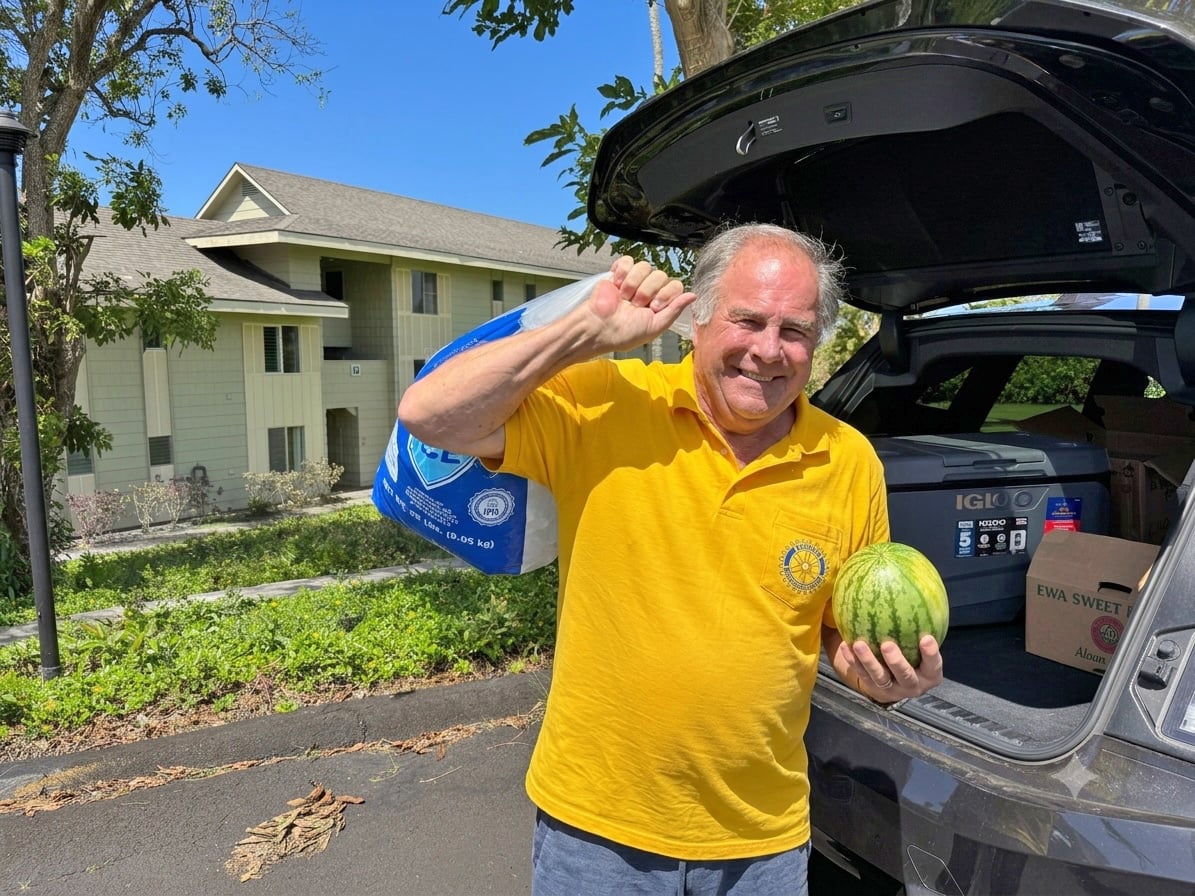 Mark Wolfendale, President of the Rotary Club of Hanalei Bay, delivers food to kupuna at a Princeville condo