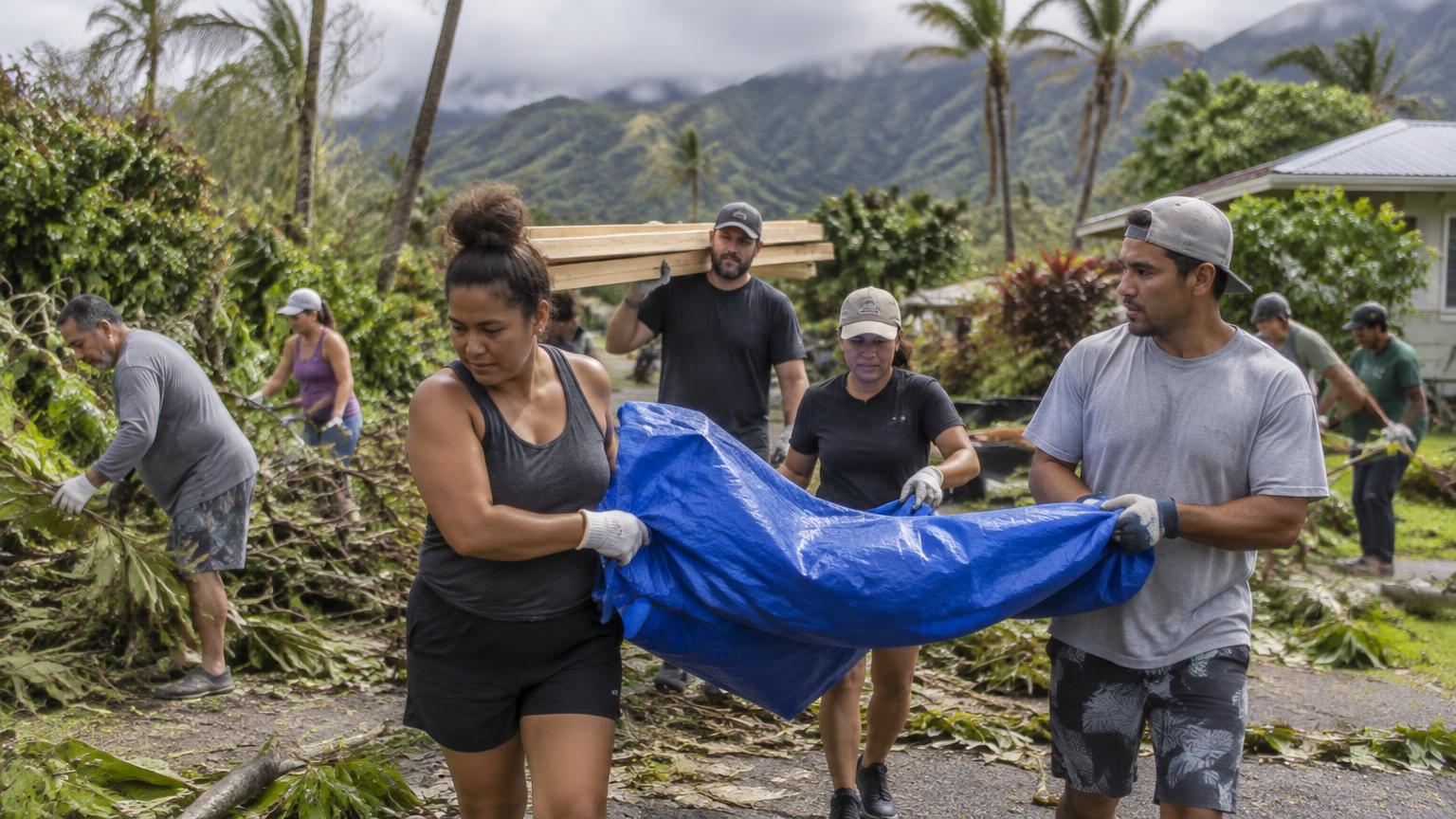 Kauai neighbors working together to clear hurricane debris and carry recovery supplies